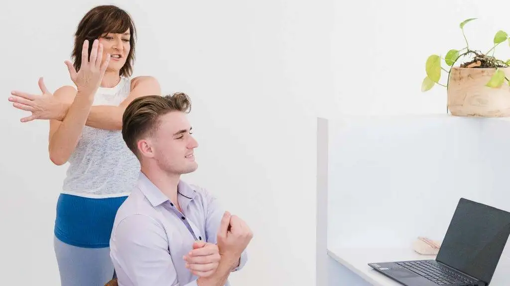 Man and woman stretching in office