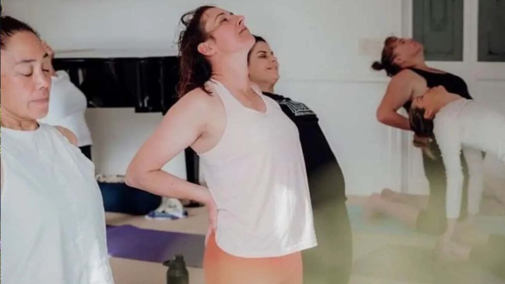 Group of people in yoga class on mats